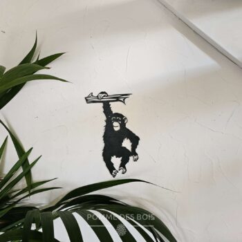 Un singe qui se pend sur une branche.